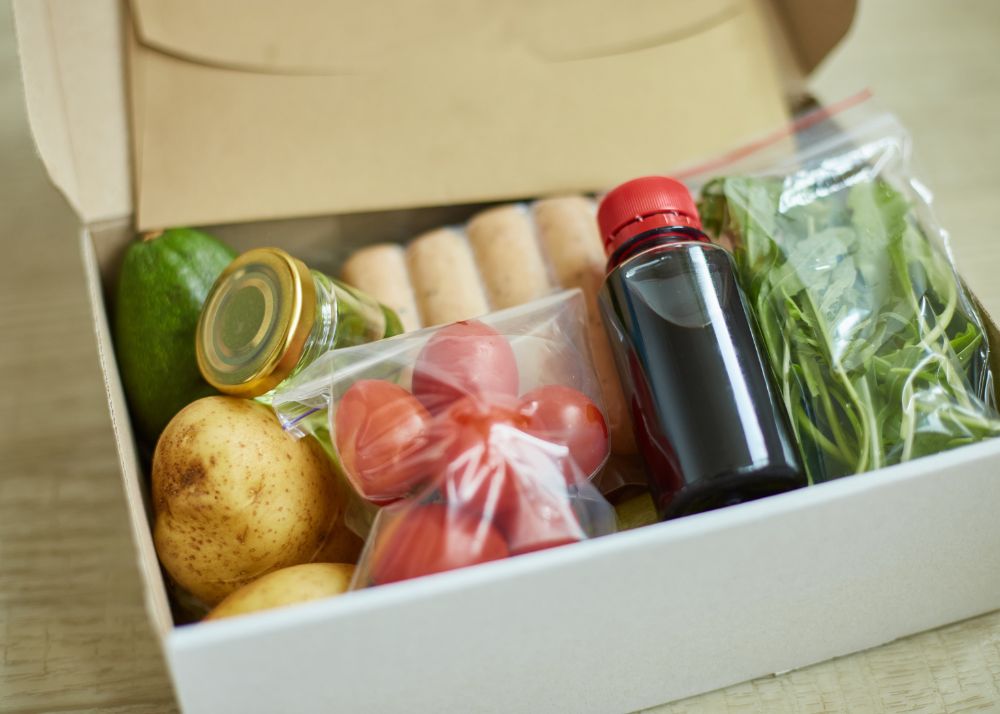 Displayed is a opened meal delivery kit containing all ingredients need to cook the included recipe. 